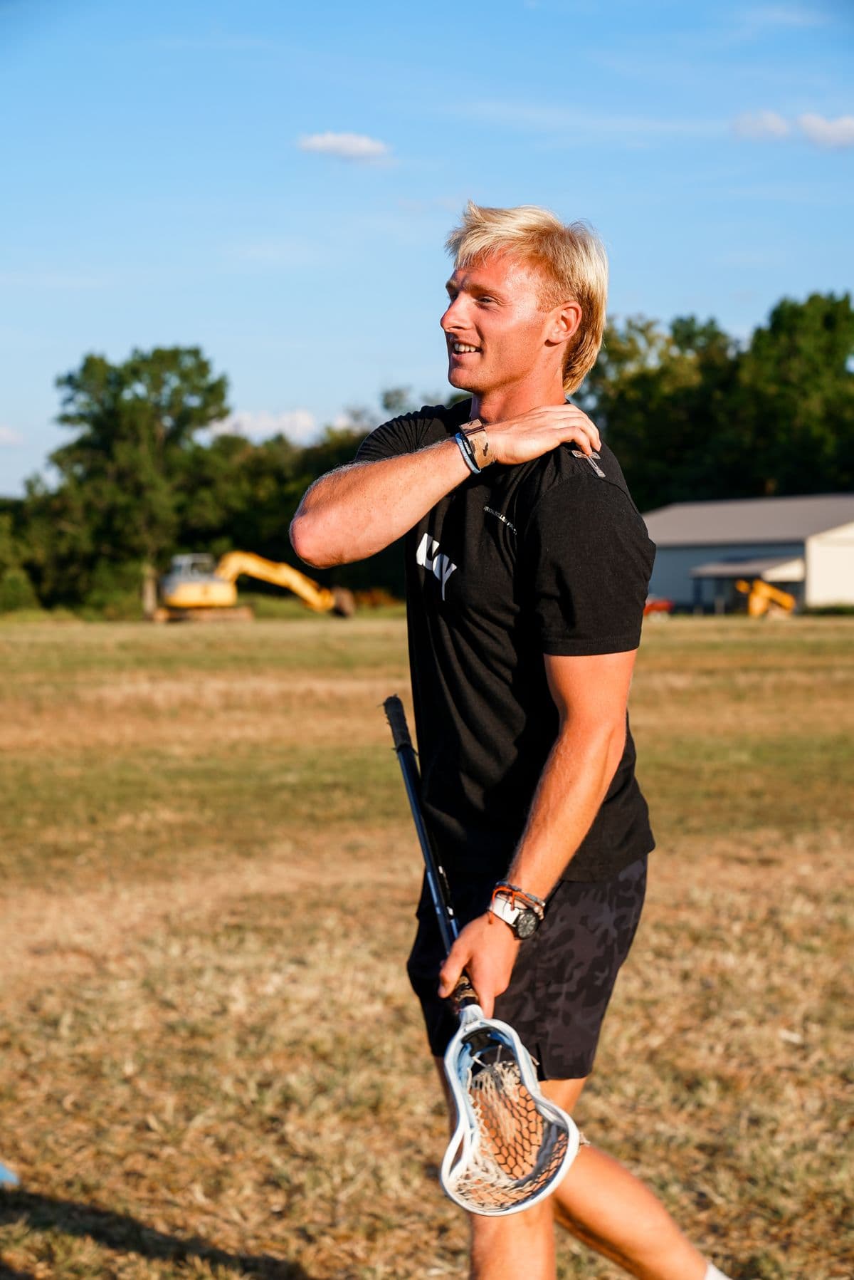 Henry Schertzinger on the field at The Barn, stick in hand.